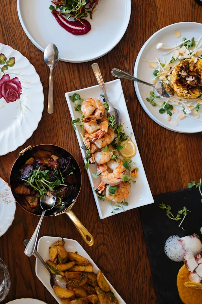Food Image 4 An overhead view of a beautifully arranged dining table featuring various gourmet dishes, perfect for a culinary experience.